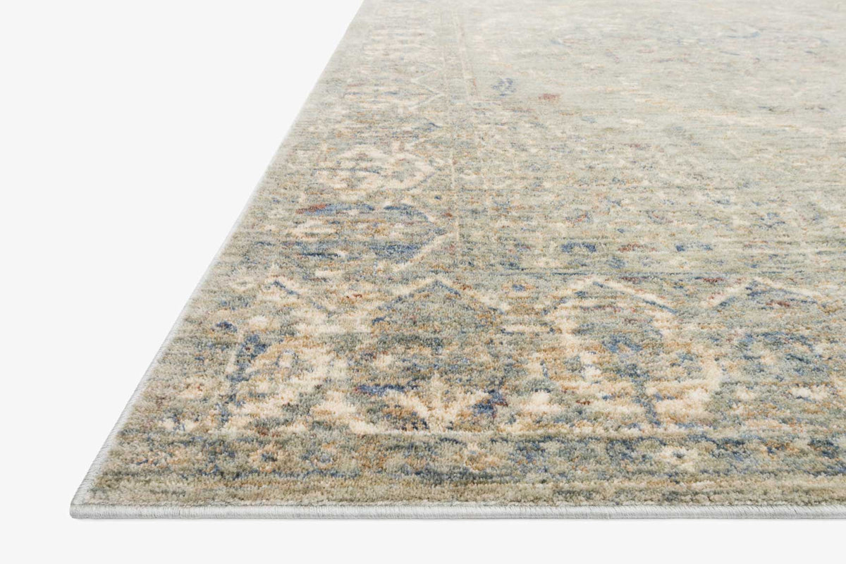 Corner view of traditional power-loomed rug with textured geometric motif, mist blue-gray
