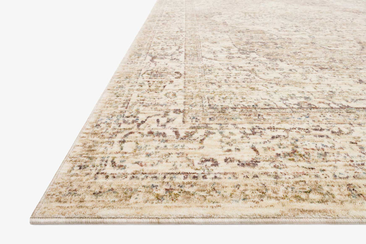 Ivory traditional rug with distressed, scattered motifs and low-profile woven border