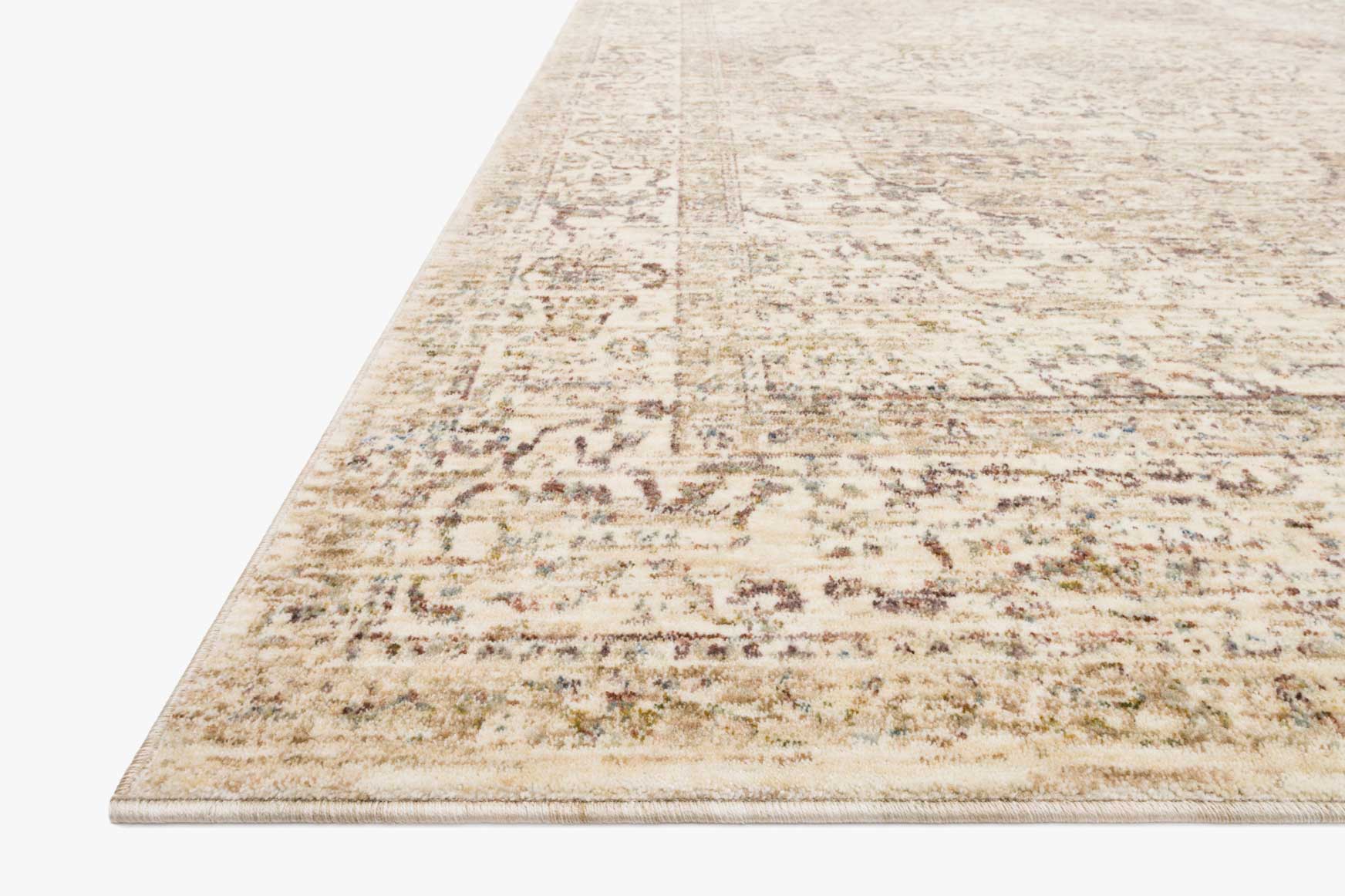 Ivory power-loomed rug corner detail with distressed pattern and flat weave