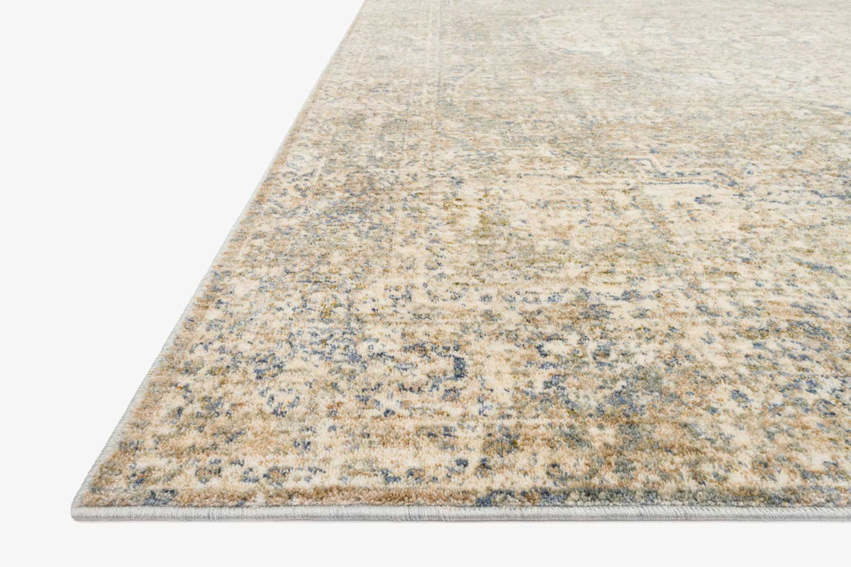 Power-loomed area rug, light beige-gray with scattered blue motifs and flat border