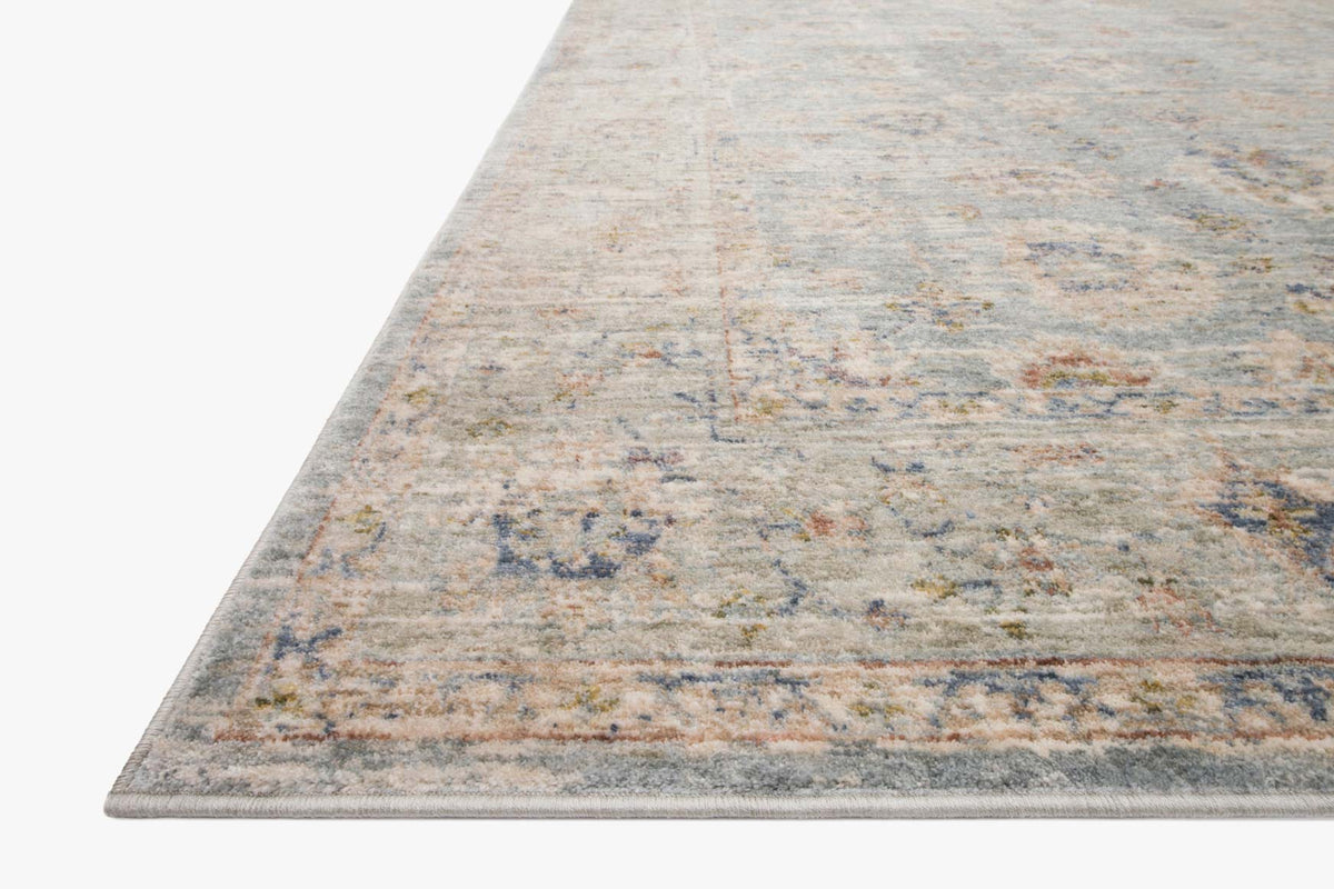 Traditional power-loomed rug, light blue and cream geometric border on corner