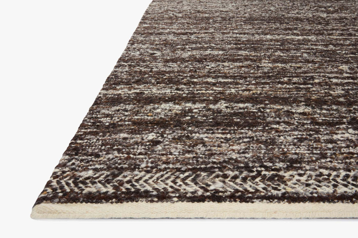 Mocha and ivory handwoven rug, angled view with trimmed edge and textured loops