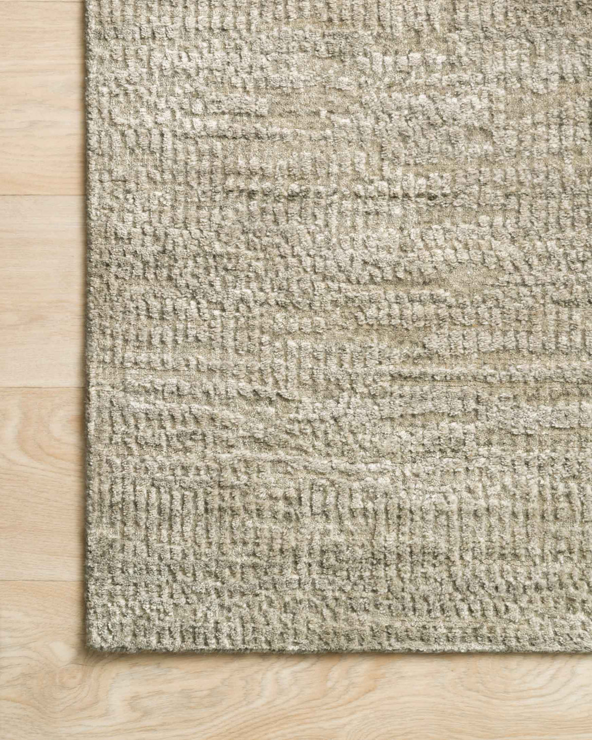 Oatmeal woven area rug close-up with raised looped texture and linear pattern