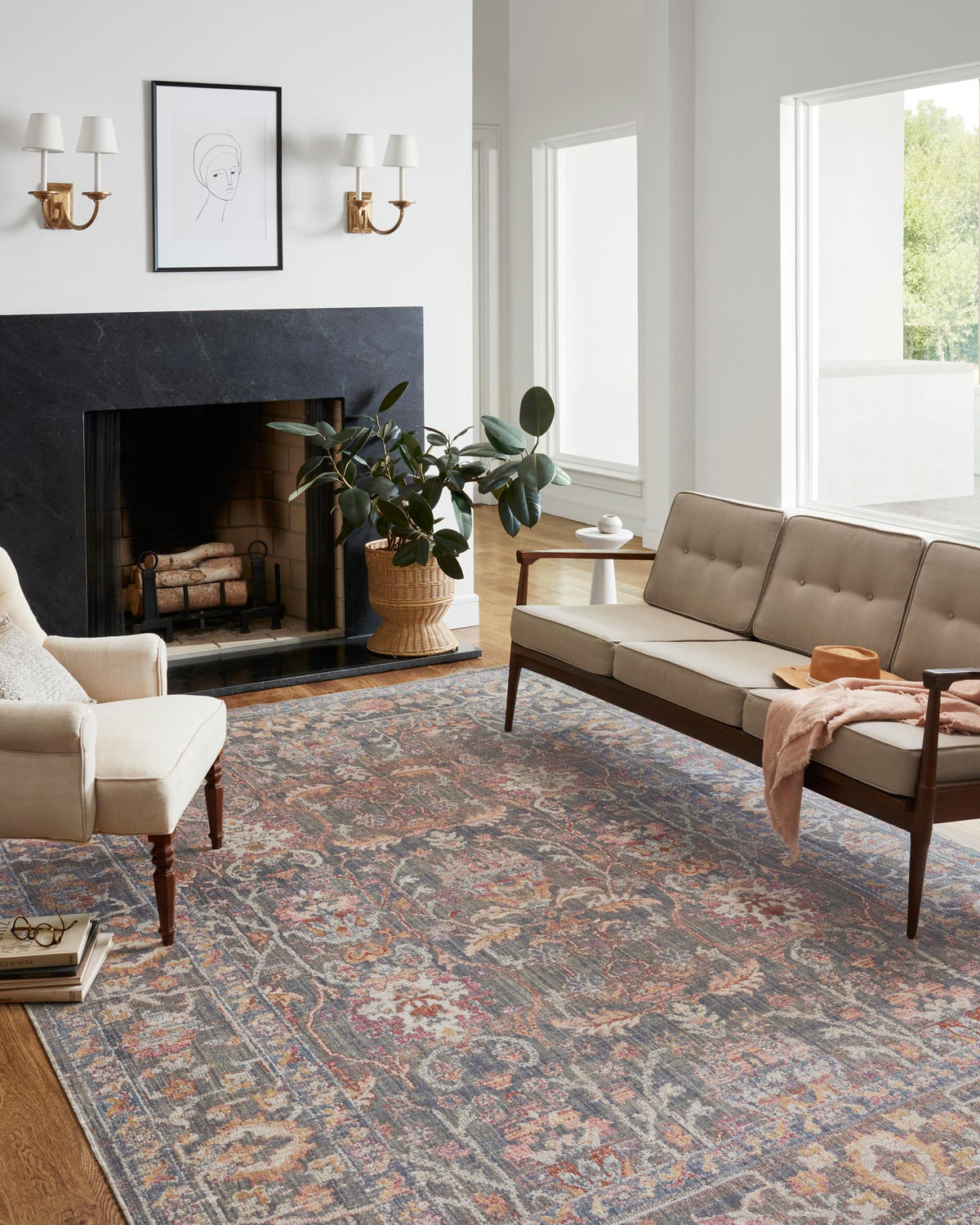 Stone-toned traditional area rug with intricate multicolor pattern laid on wood flooring