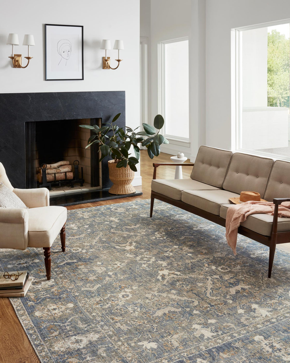 Sand and blue area rug with ornate distressed pattern in a living room setting