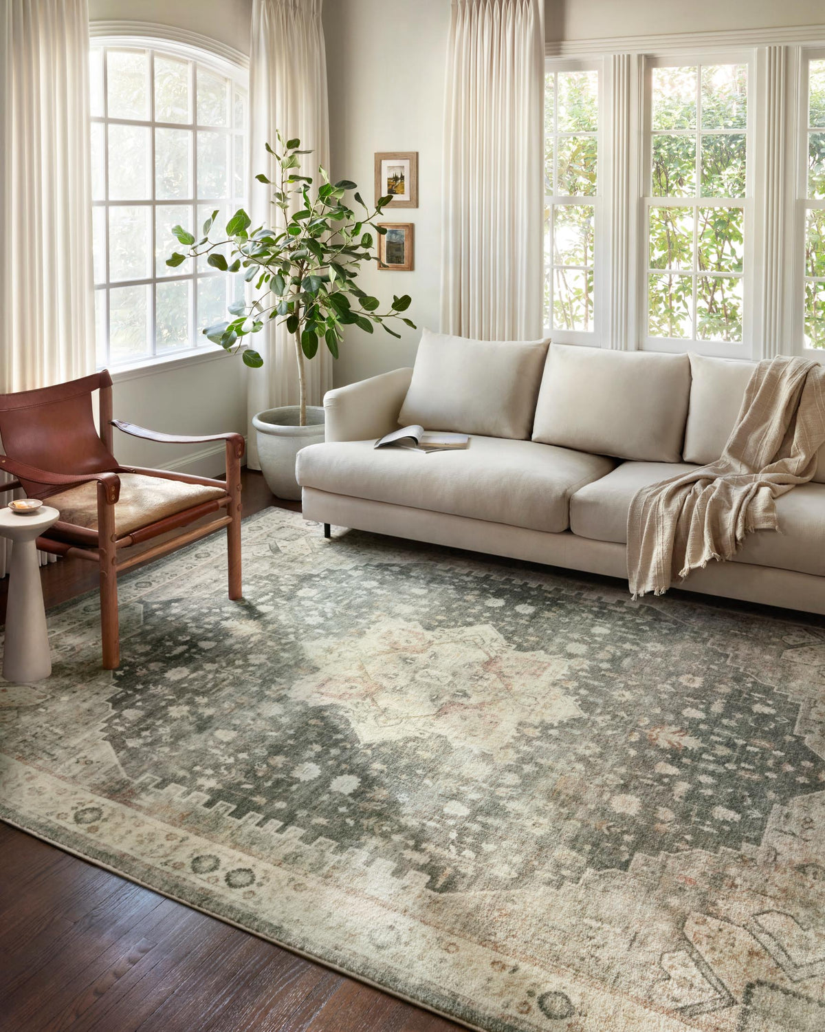 Traditional area rug with distressed slate-blue and ivory geometric pattern, full layout view.