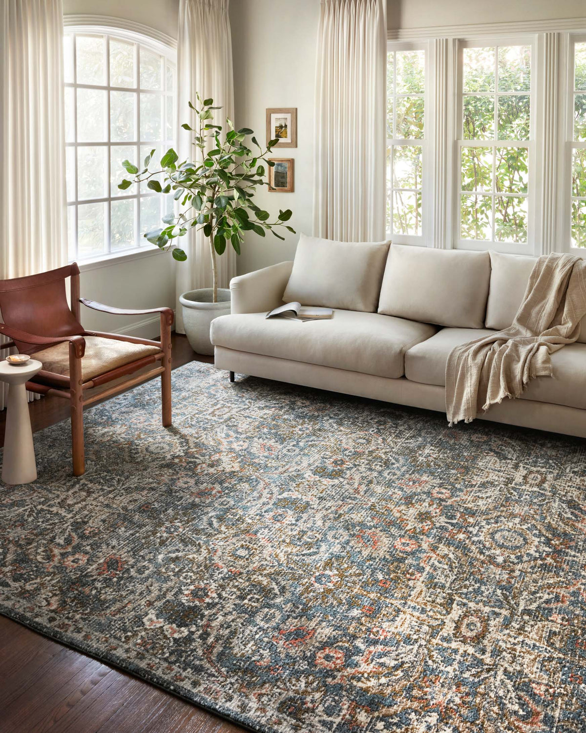 Blue and sand traditional rug with distressed ornate motif pattern, rectangular.