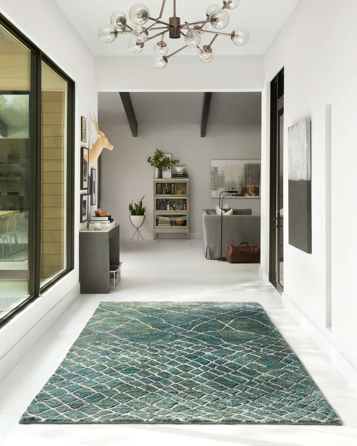 Rectangular teal area rug with white lattice diamond pattern
