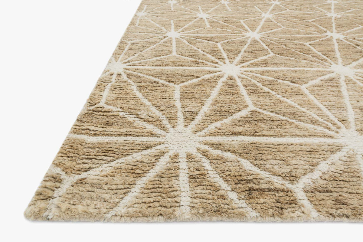 Ivory hand-knotted rug corner detail with white starburst geometric pattern