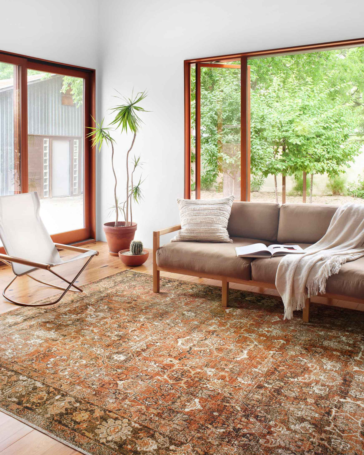 Traditional power-loomed area rug in rust and tobacco with intricate central medallion
