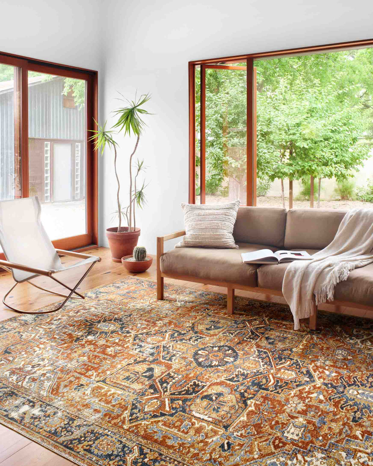 Red, navy and cream traditional patterned rug laid across the floor