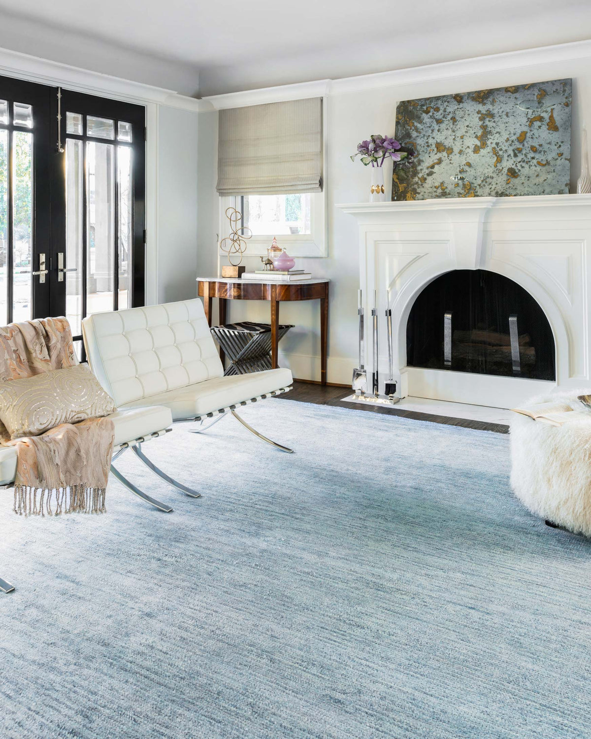 Light blue area rug with dense textured pattern and low pile, rectangular