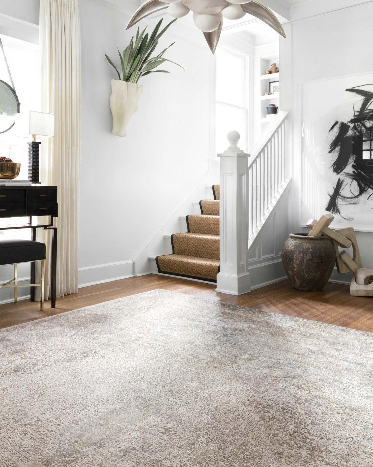 Ivory and pebble power-loomed rug covering the floor with mottled abstract design