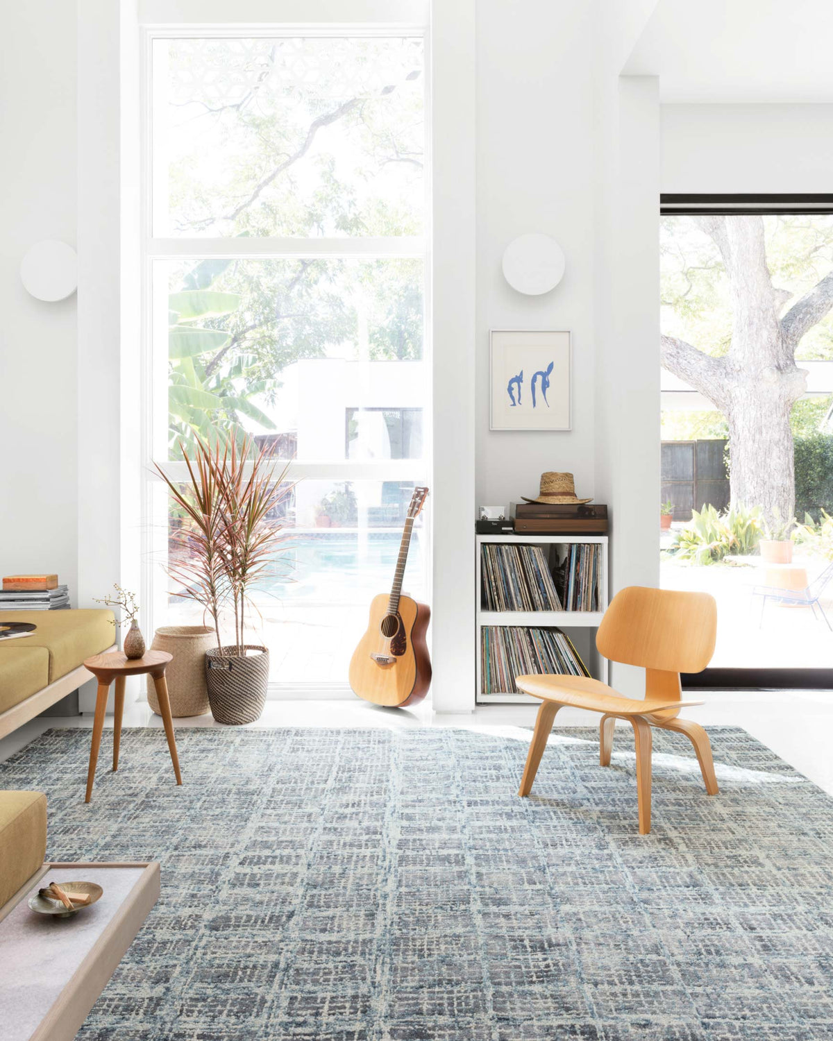 Blue abstract hooked area rug with textured grid pattern and distressed look