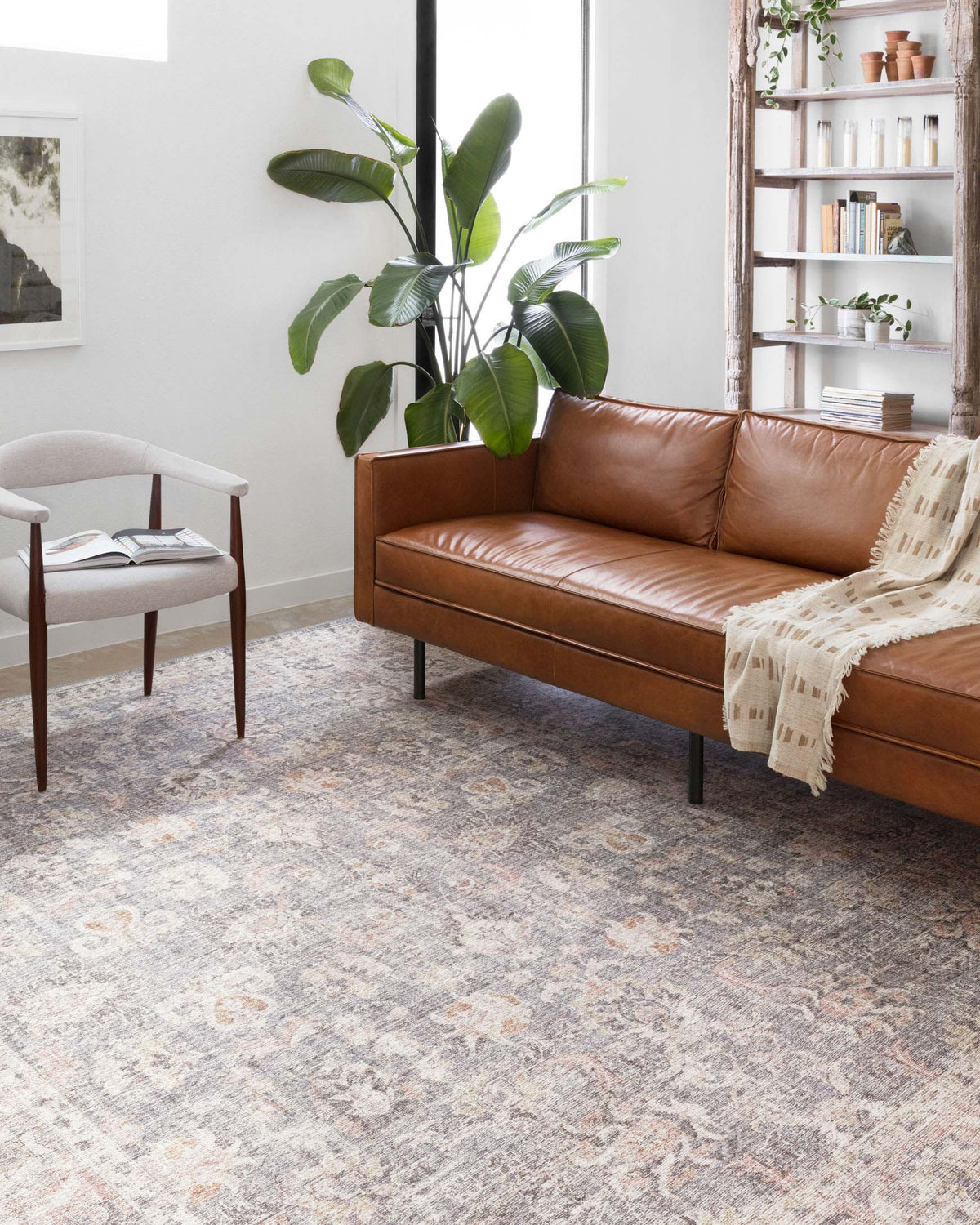 Grey and apricot patterned area rug with distressed motifs