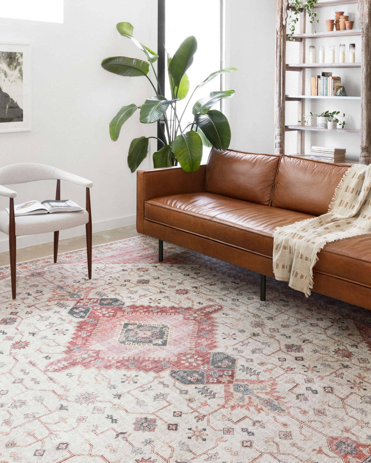 Traditional power-loomed rug with ivory ground and muted berry geometric motifs