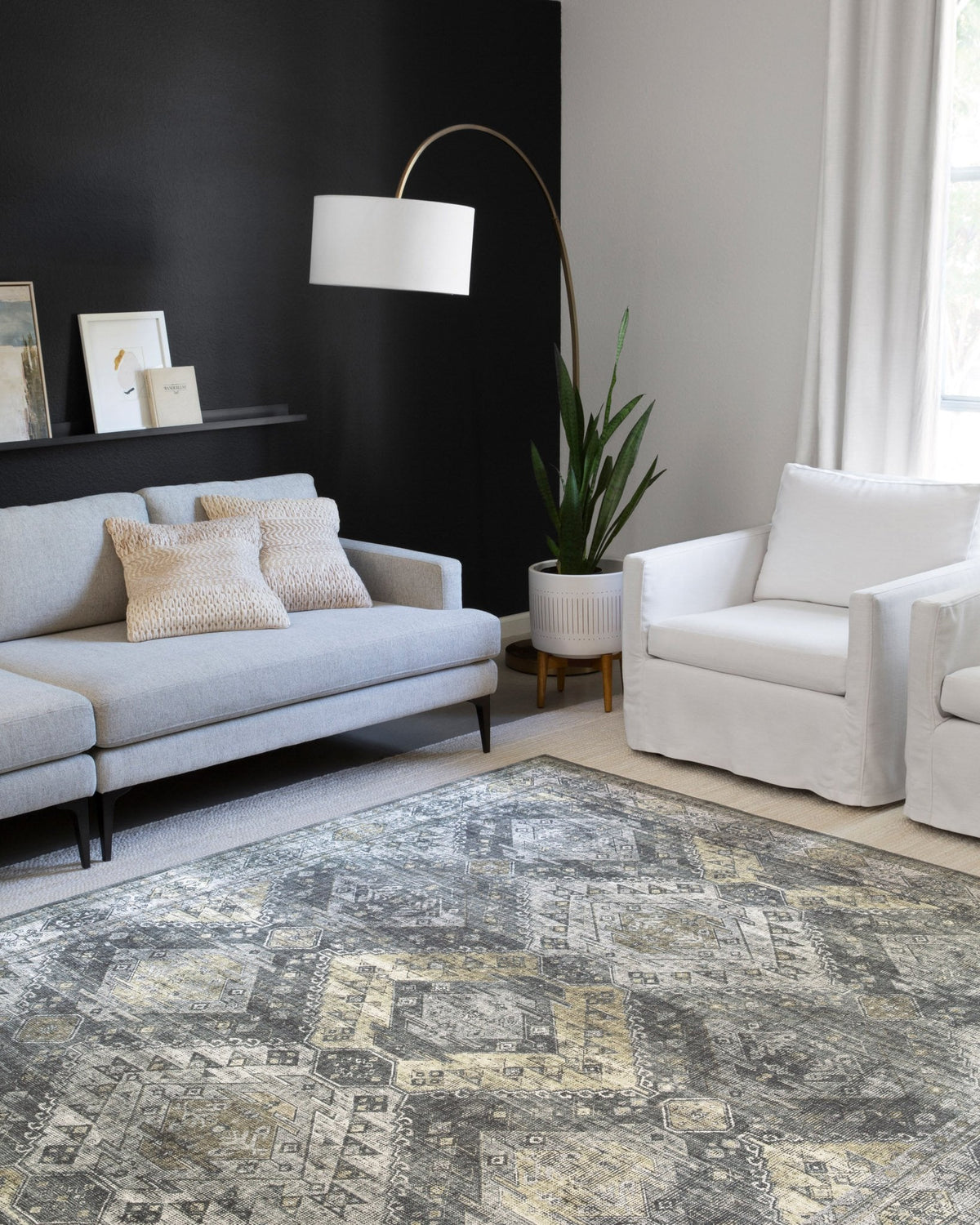 Geometric graphite and silver rug with gold-toned highlights on display in a living room