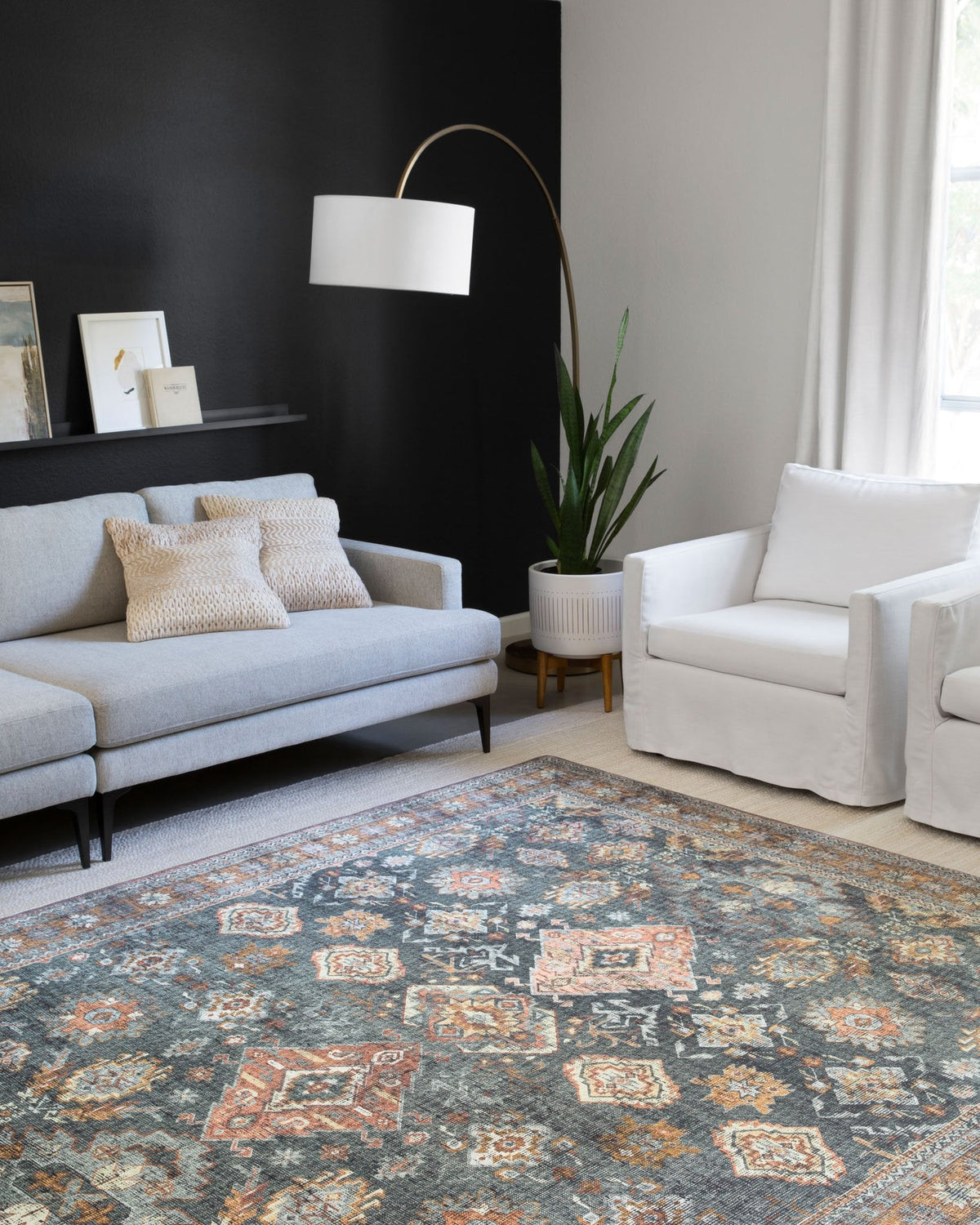 Traditional power-loomed rug with sea blue ground and rust motifs, wide patterned border