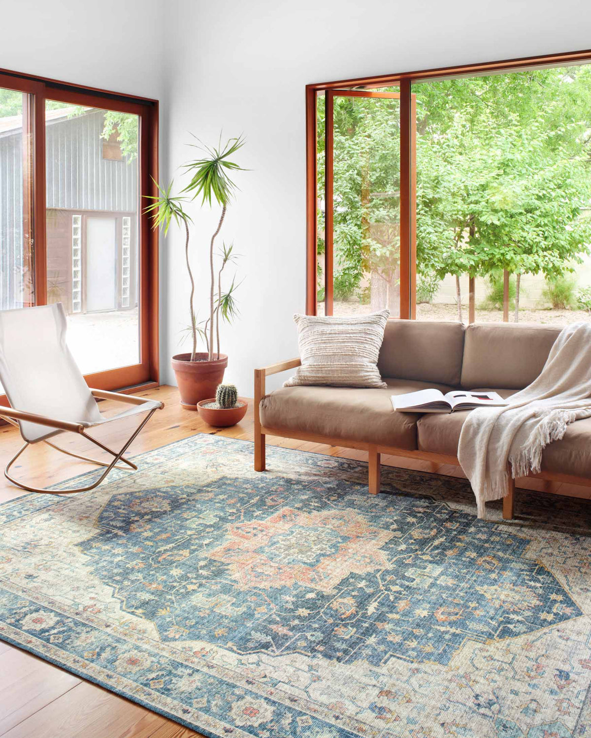Ocean-blue rug with ornate distressed motif and multicolor accents