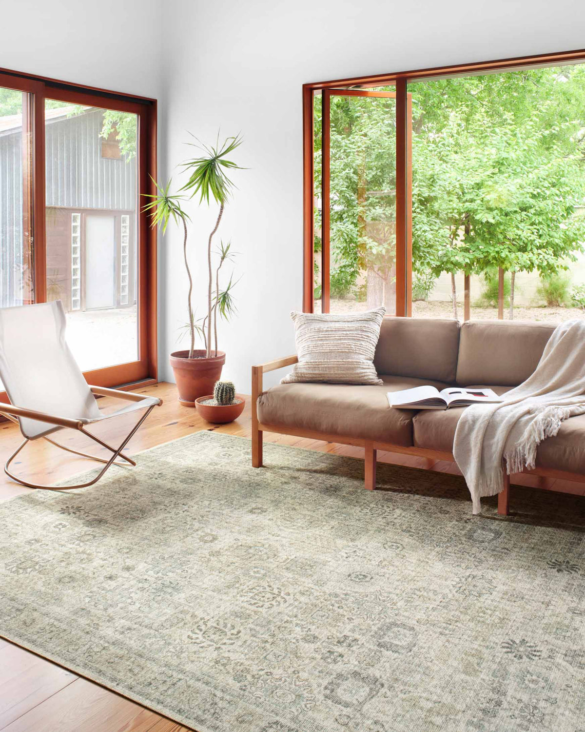 Power-loomed rug in natural and sage with distressed geometric motifs