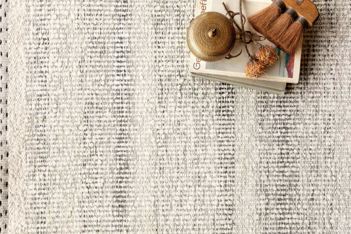 Flatwoven rug surface with speckled smoke-gray and cream texture, close-up