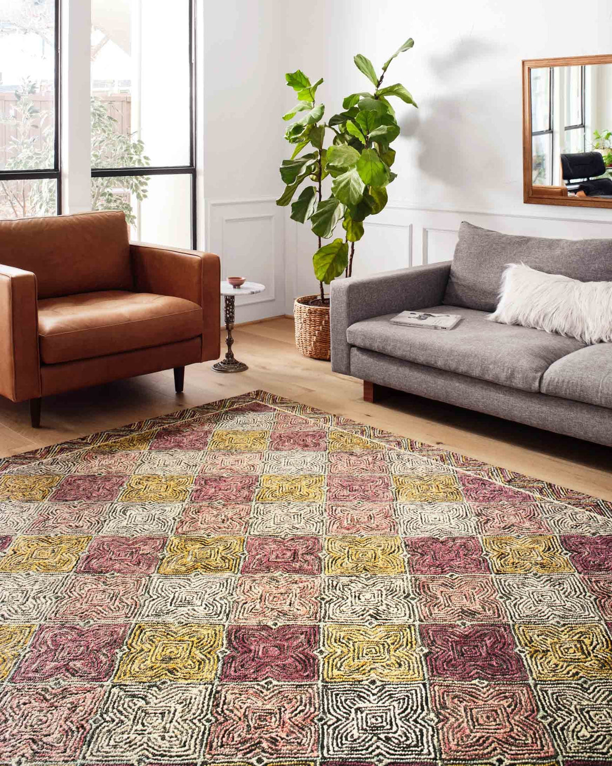 Multicolor hooked area rug with geometric blocks and maze linework on the floor
