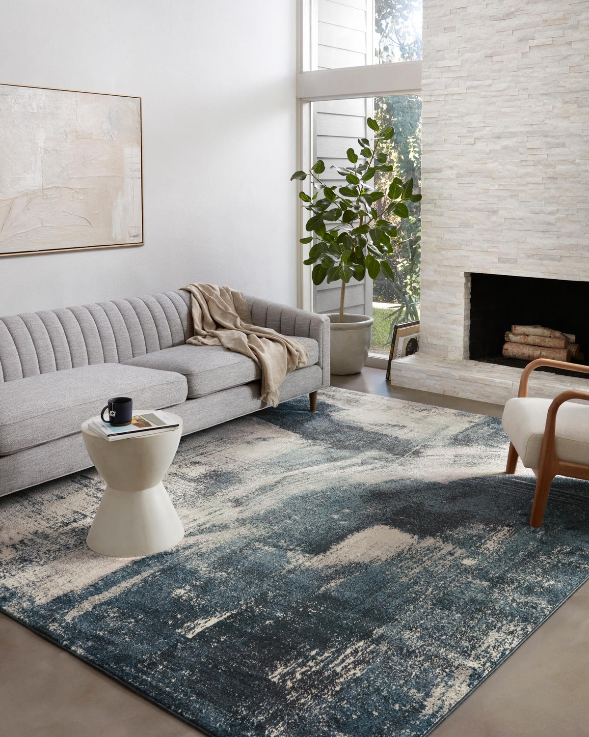 Indigo and ivory abstract area rug with distressed texture and short pile.