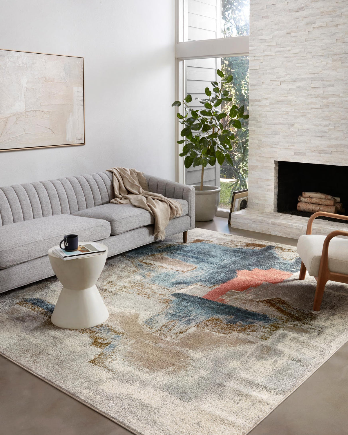 Stone area rug with distressed abstract blocks in blue, teal, and rust tones.