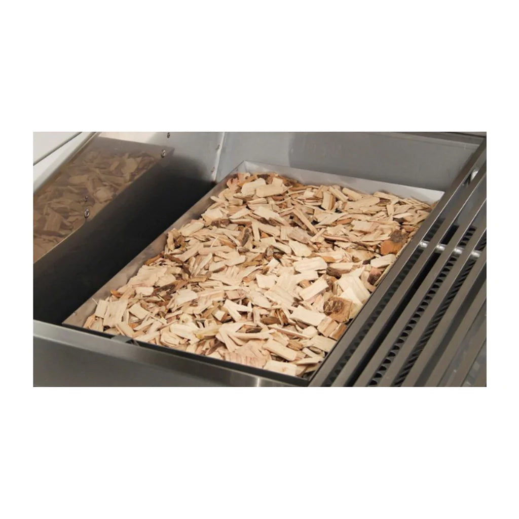 Wood chips in a stainless smoker tray inside the grill