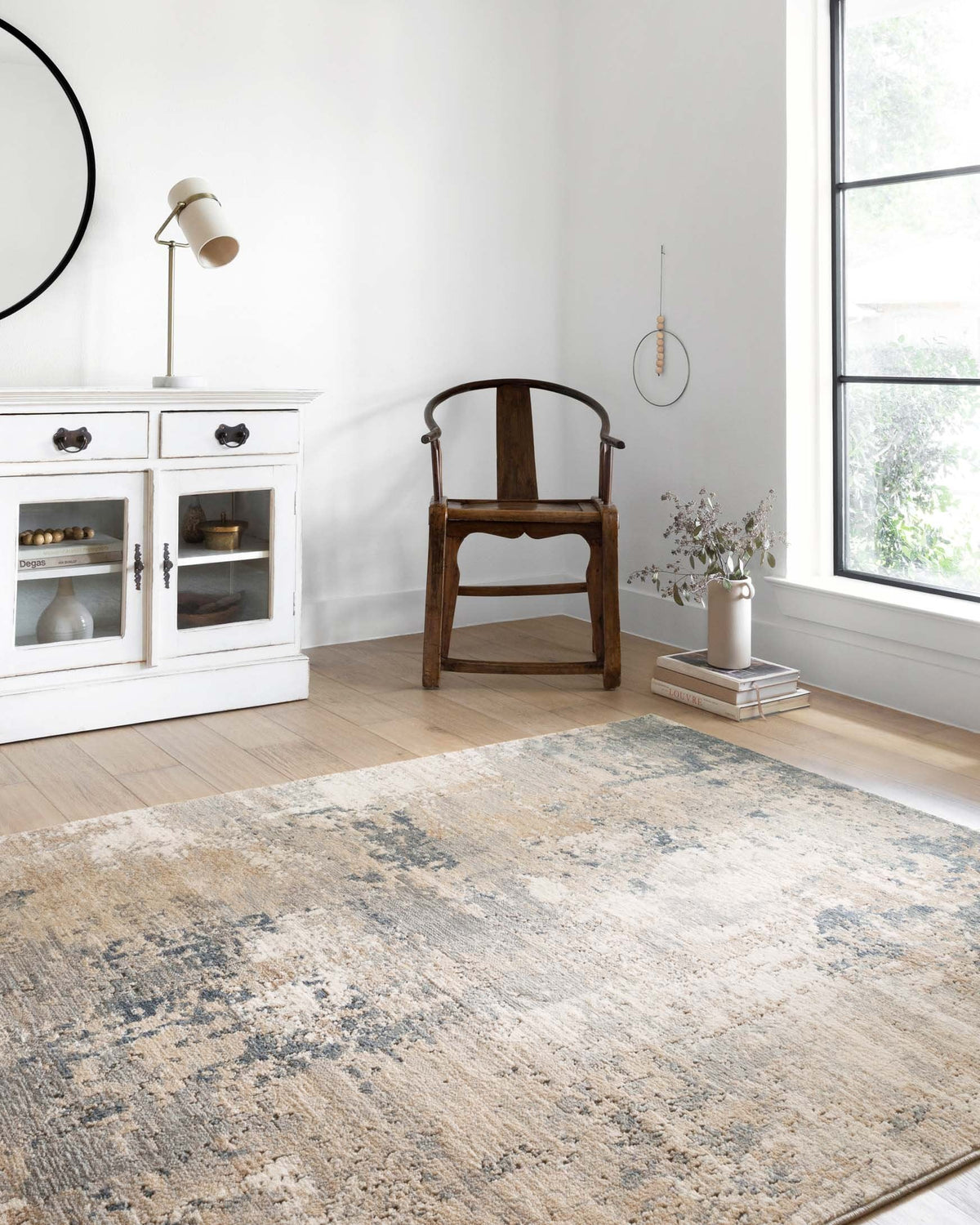 Sand and mist abstract power-loomed rug on light wood floor, rectangular.
