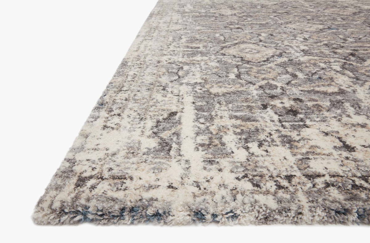 Natural and grey rug corner detail with distressed geometric pattern and short pile