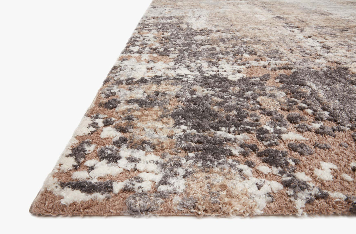 Taupe and gray area rug with abstract mottled design, dark and light flecked texture.