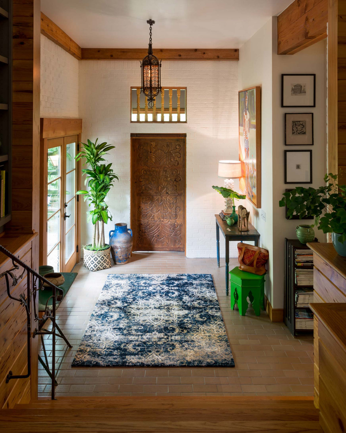 Navy and ivory area rug with distressed ornate pattern, placed in a hallway
