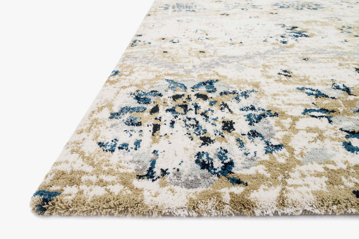 Ivory rug corner with blue abstract floral motifs and textured low-pile surface