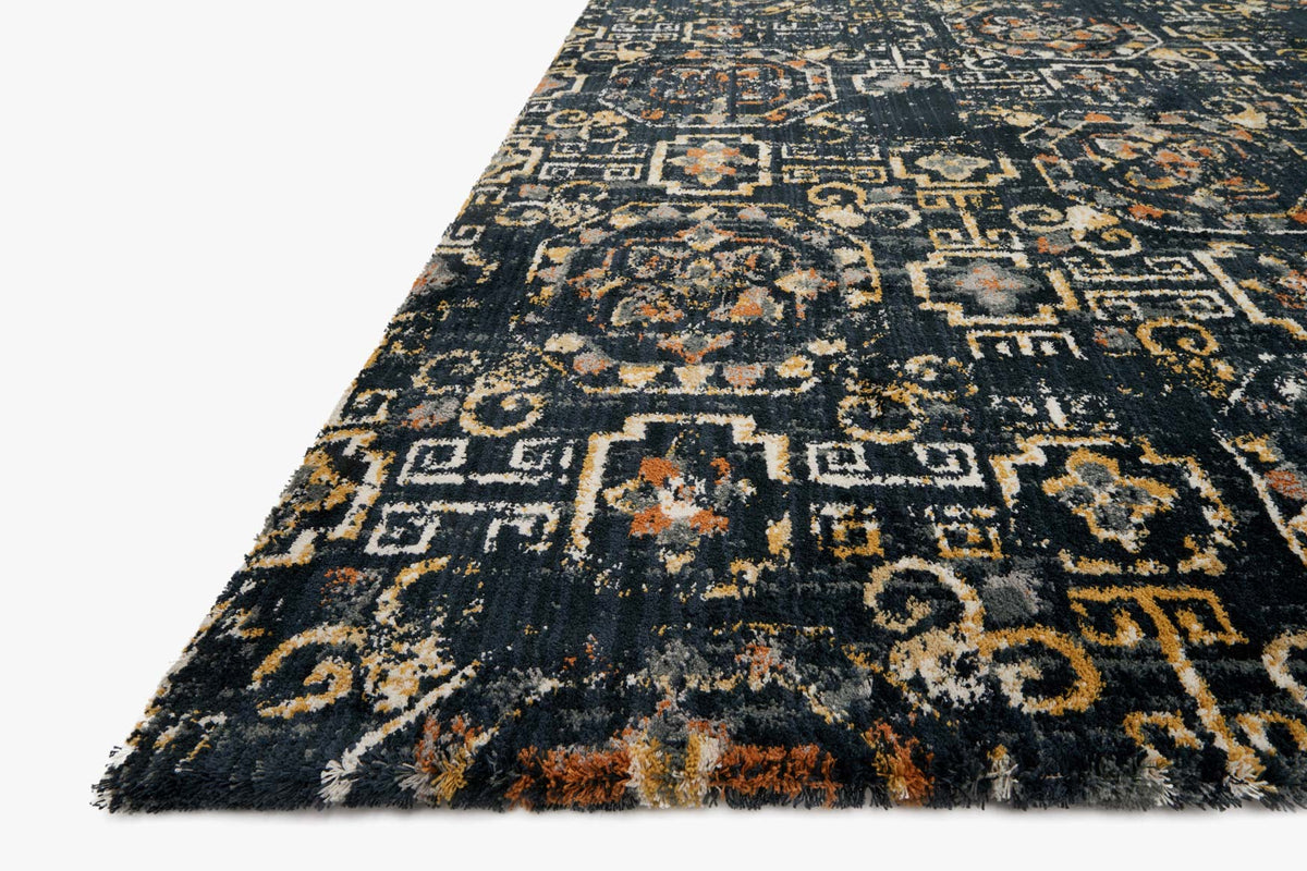 Midnight geometric rug with medallion motifs, distressed gold, tan, and rust tones