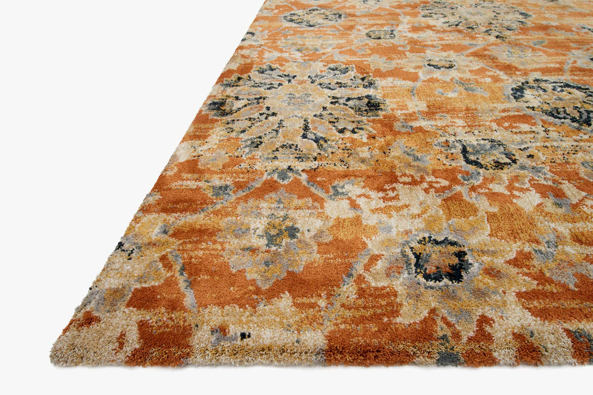 Rust-orange rug with faded floral motifs and dark medallion centers, angled view