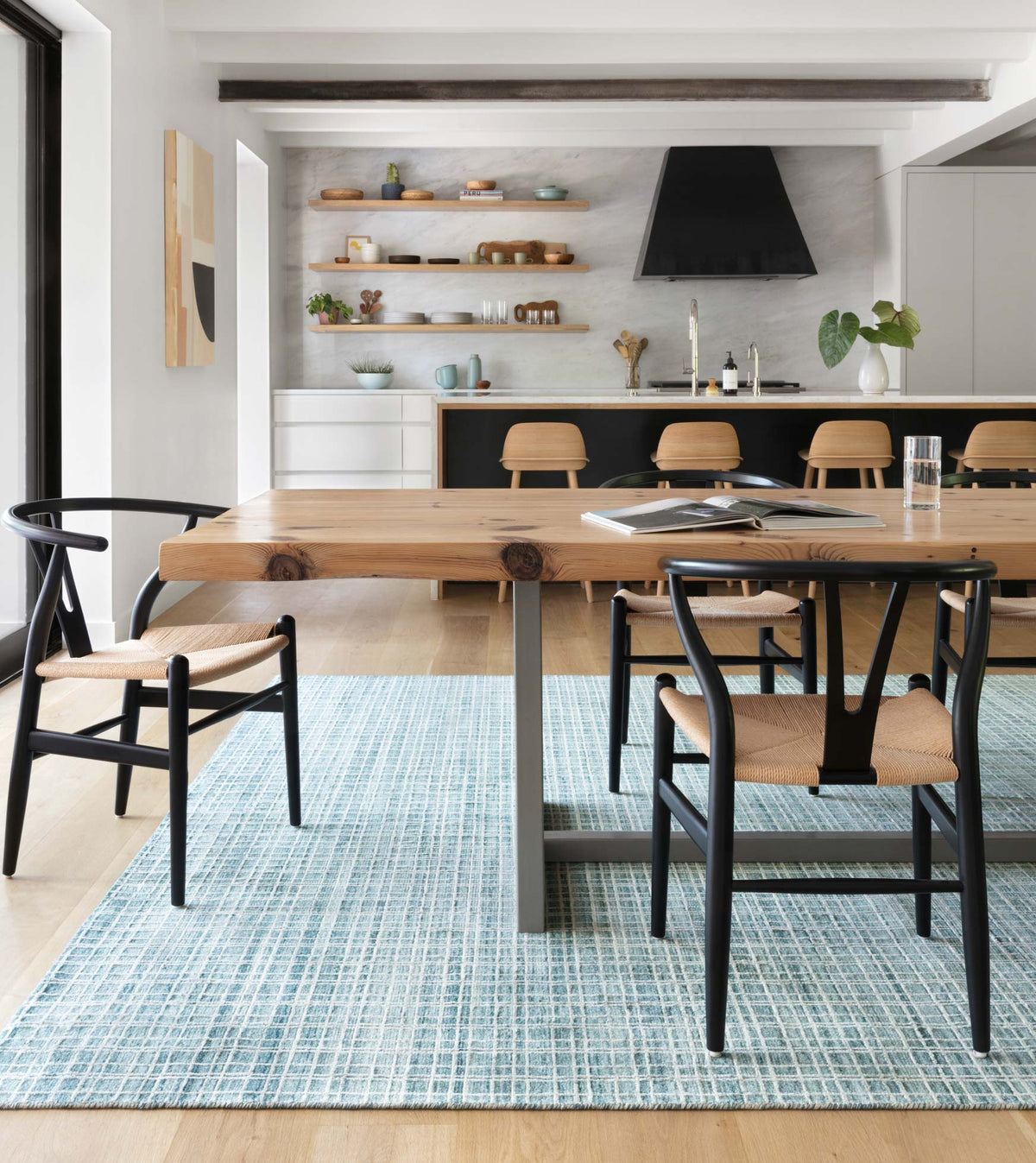 Aqua grid-pattern transitional hand-loomed rug beneath dining chairs