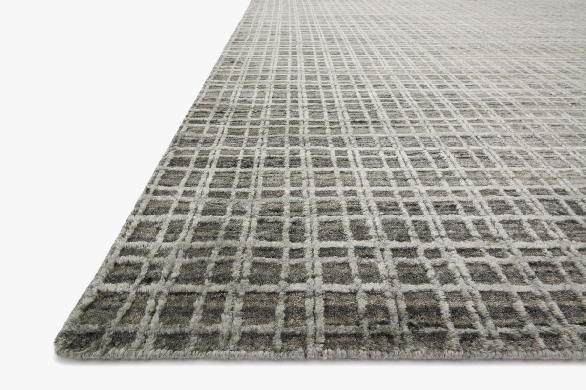 Hand-loomed rug corner with gray and graphite plaid grid pattern