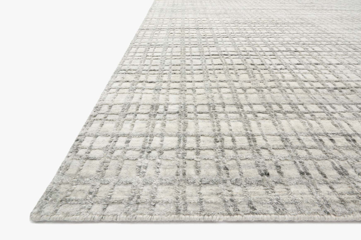 Silver hand-loomed rug with raised textured grid and fringe-free low pile