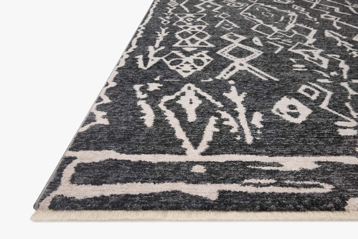 Charcoal and dove geometric rug with wide border and patterned field, corner view.