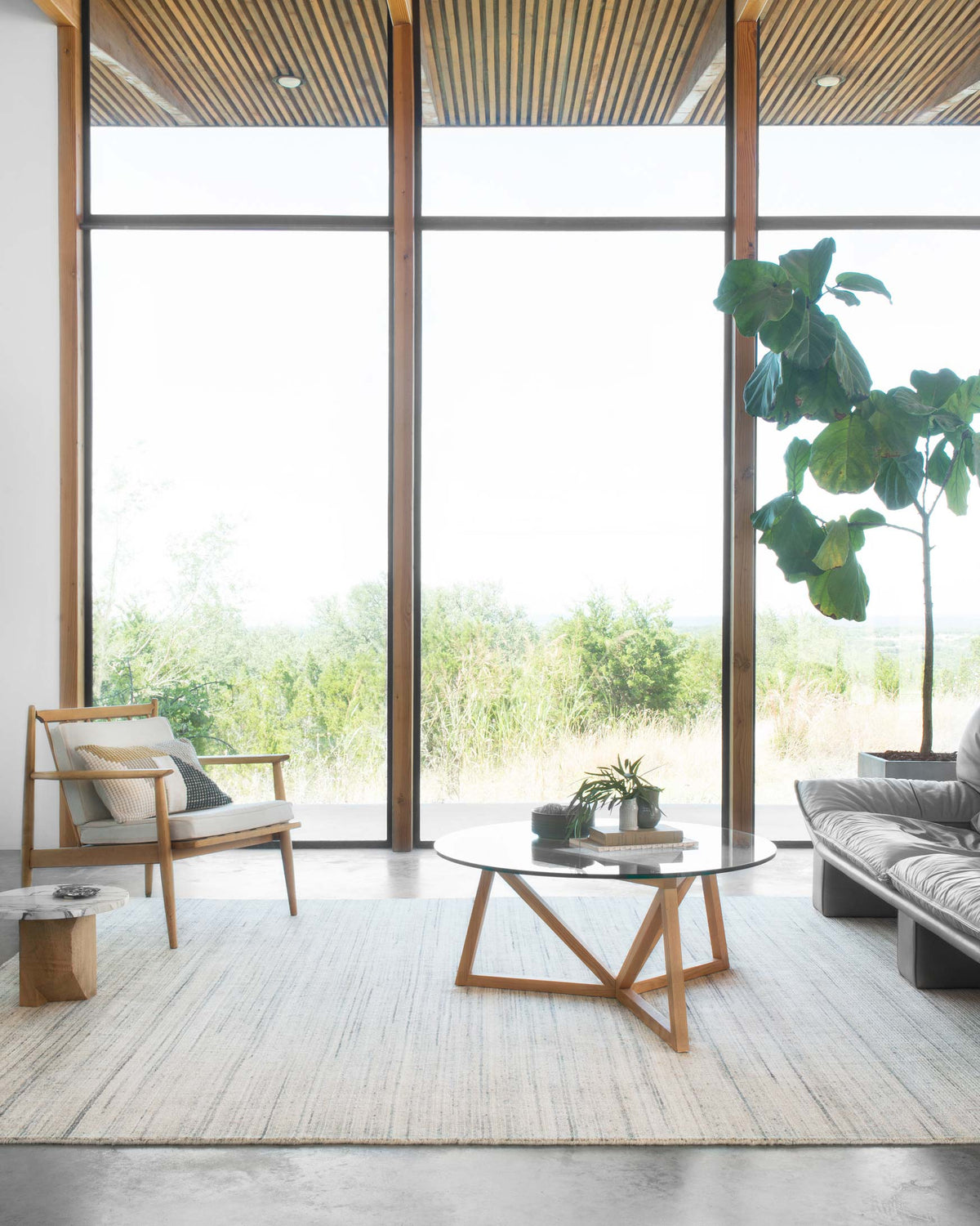 Ivory area rug with thin horizontal stripes and speckled weave in a living space.