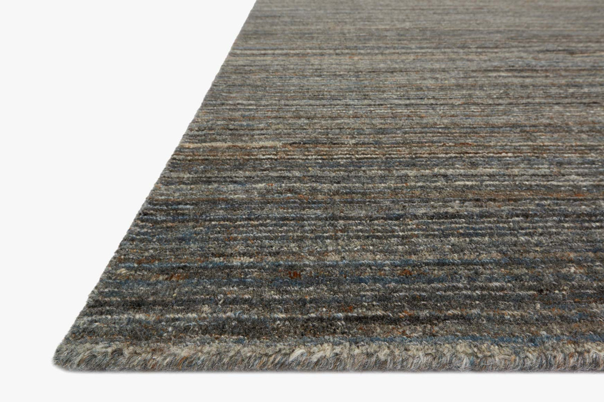 Slate hand-loomed rug corner with fringe and thin horizontal stripe pattern