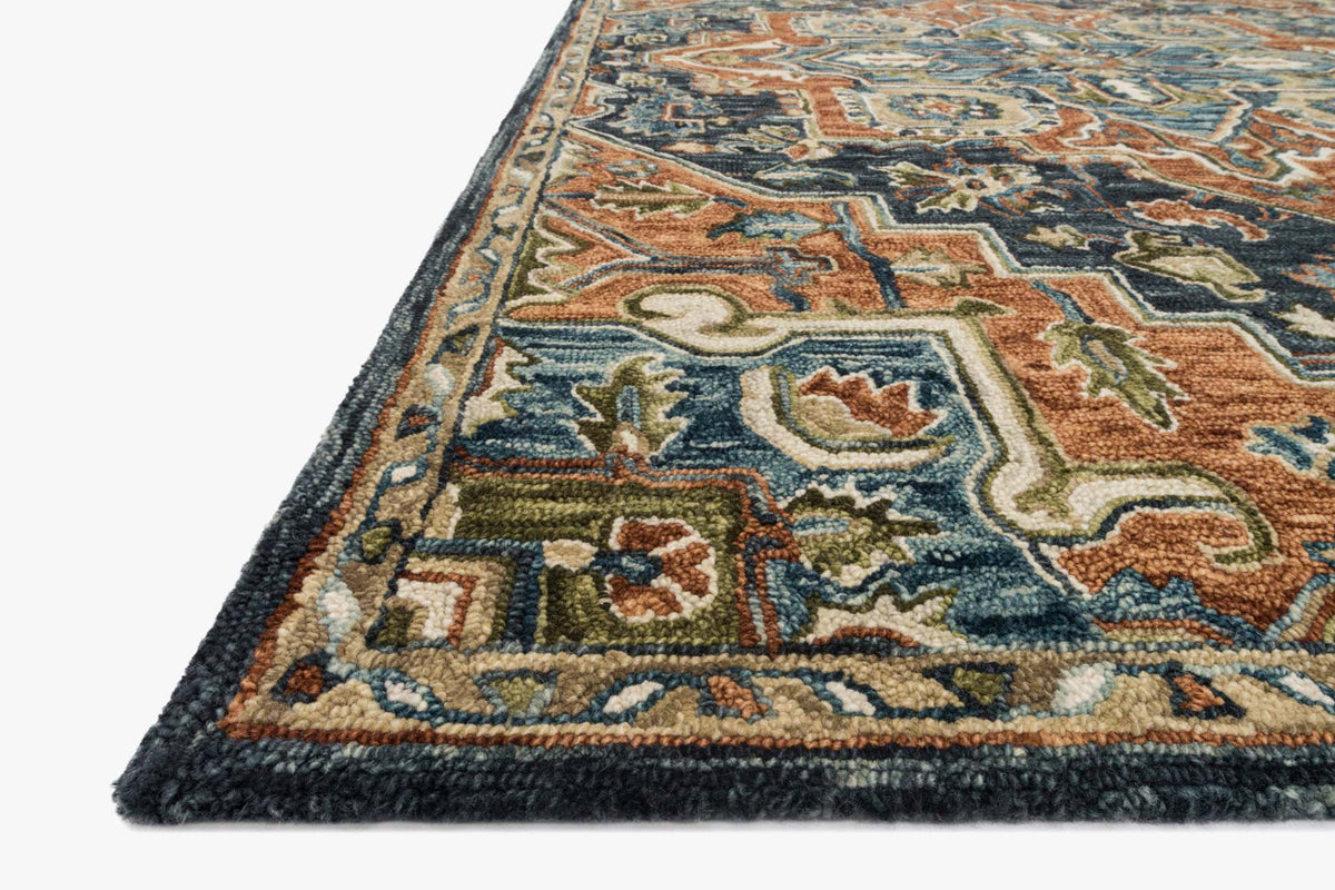 Traditional hooked rug corner detail with hooked pile pattern, rust and teal on dark base