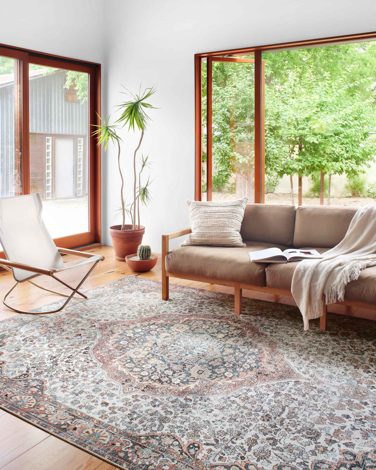 Traditional power-loomed rug with faded red and blue medallion pattern.