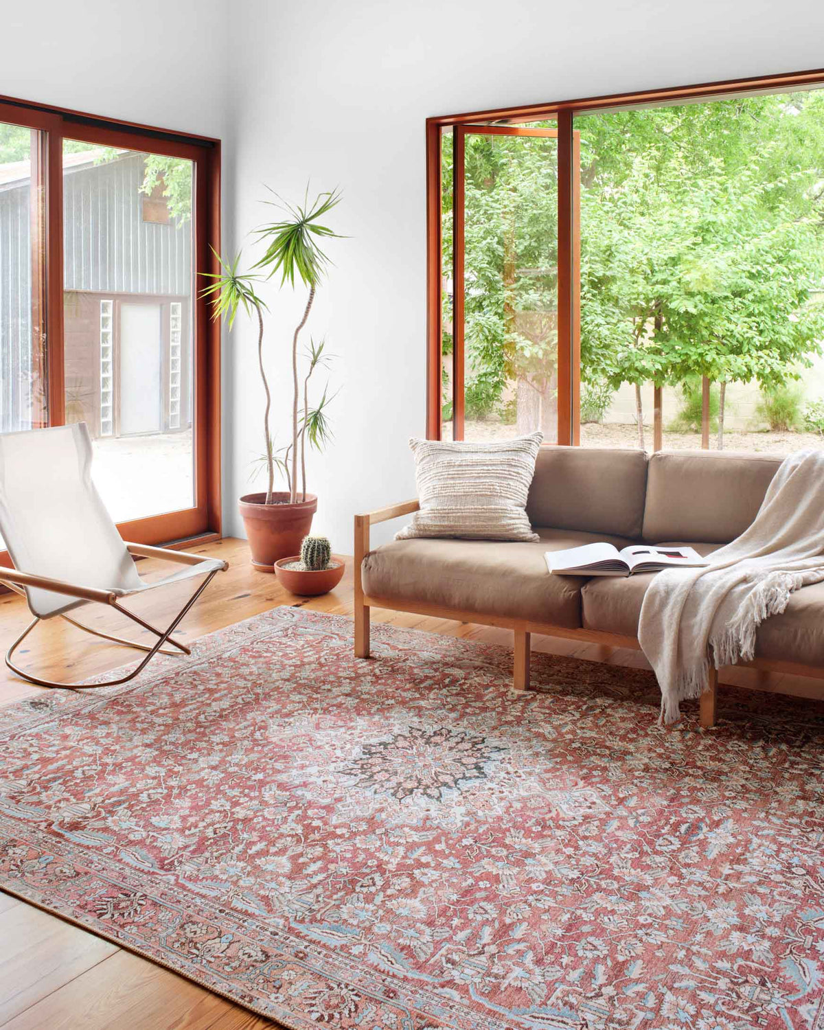 Traditional rug in pink and teal with intricate medallion-style motifs