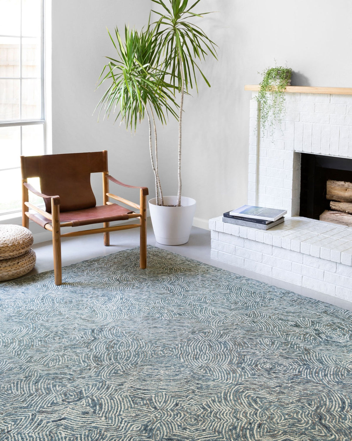Denim blue hand-tufted rug with swirling maze motif and textured pile