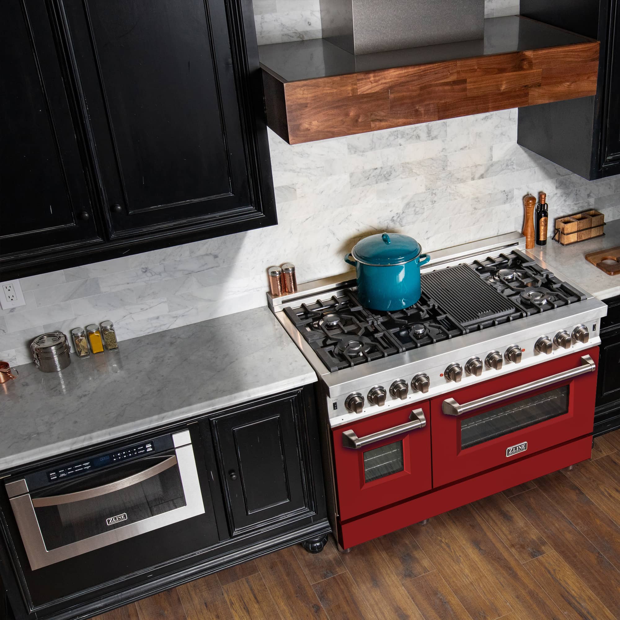 Red and stainless dual fuel range with oven window, burner grates, and control knobs