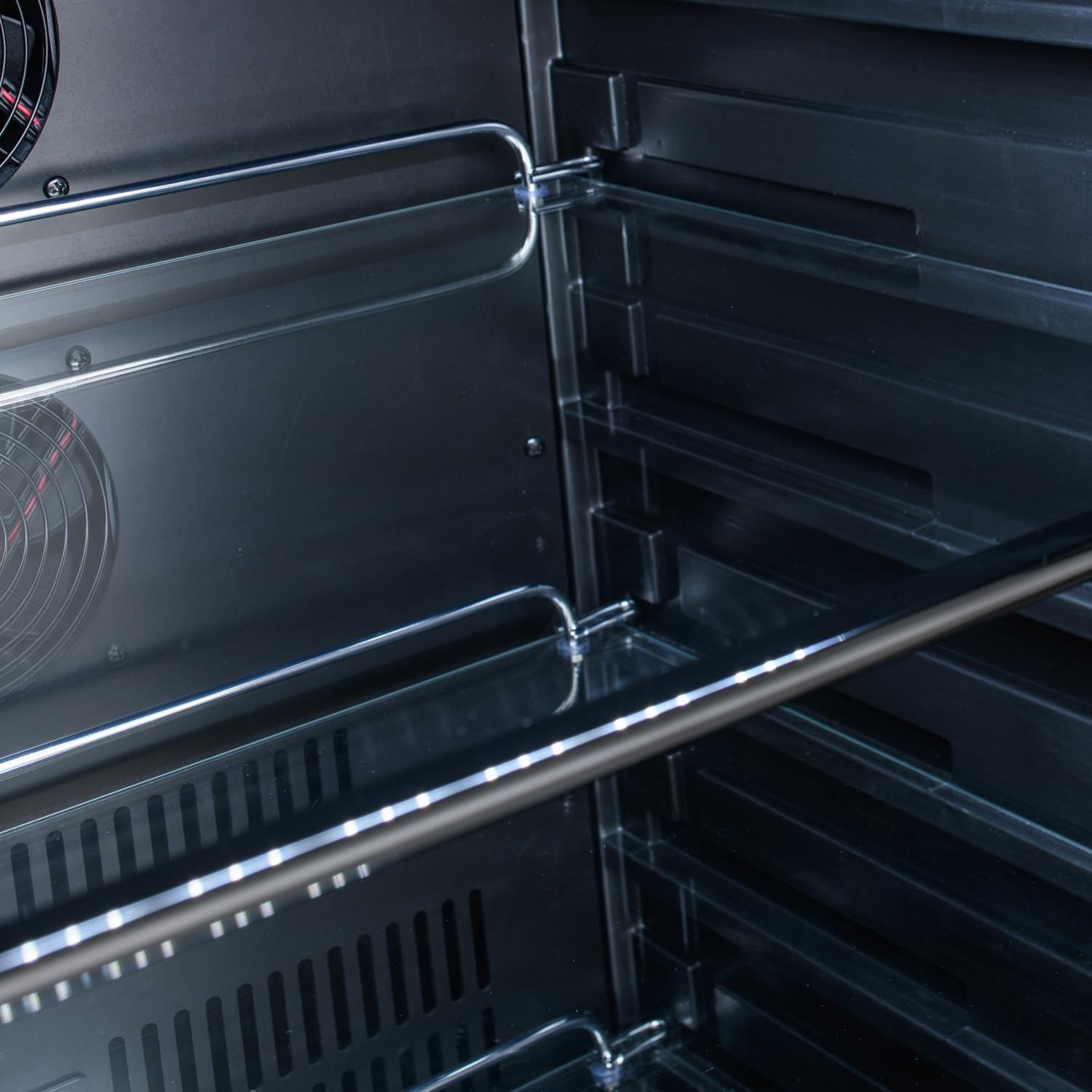 Stainless steel built-in propane grill interior with warming grates and burners