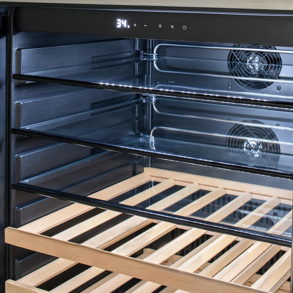 Stainless steel grill oven cavity with fan vents, heating tubes, and wooden rack