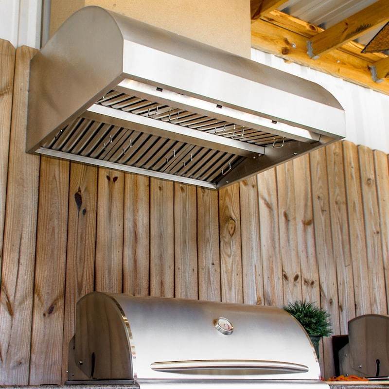 Outdoor stainless vent hood mounted above a barbecue grill with louvered filters